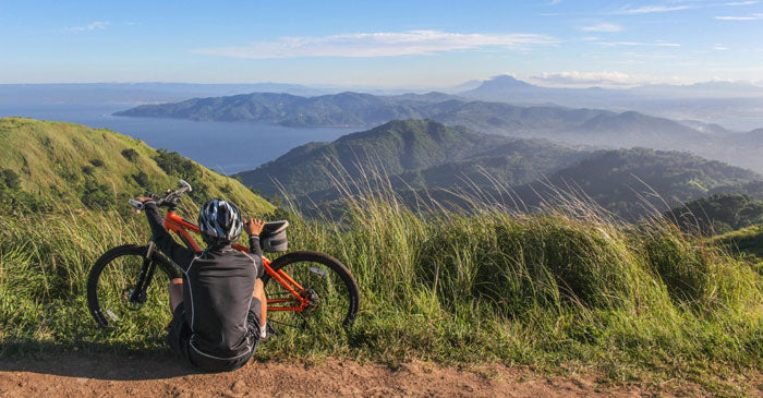 a rider sitting next to a bike