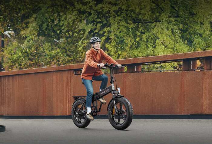 a woman riding an engwe ep-2 pro e-bike on the road