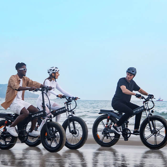 3 people ride engwe x20, x24 and x26 e-bike on the beach