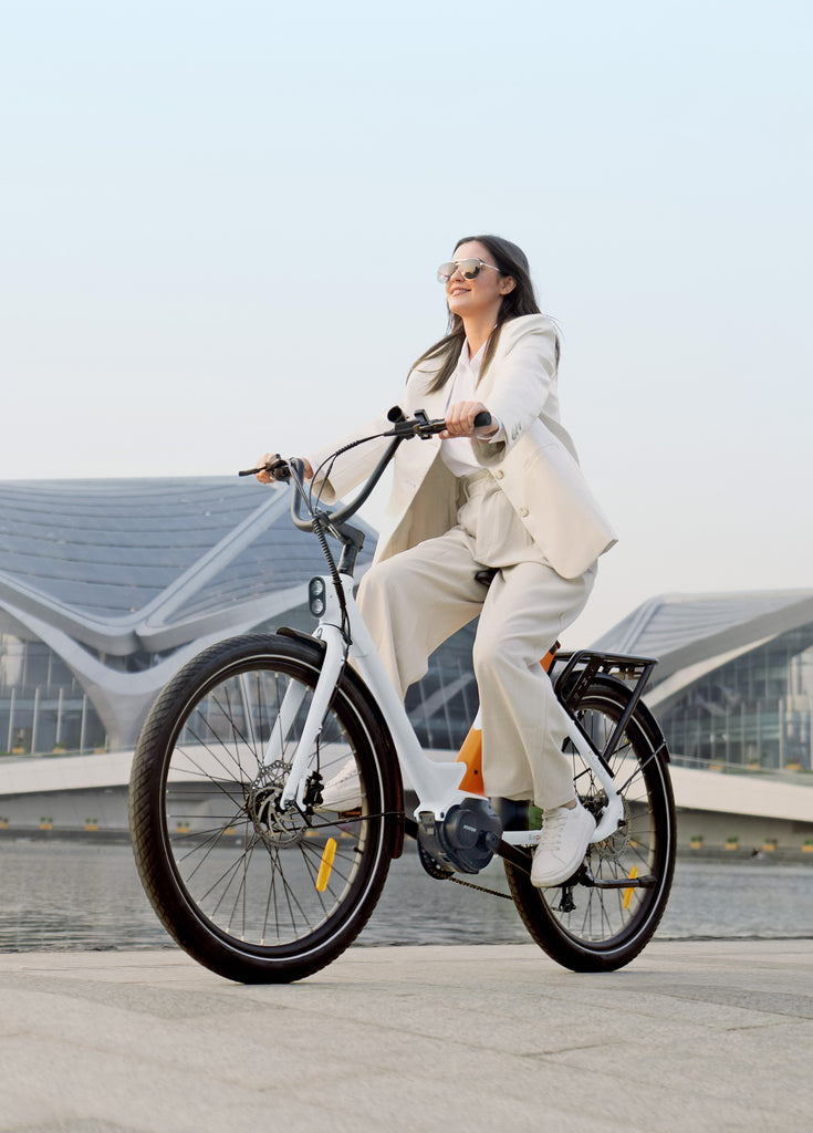 a woman riding an engwe p275 st city e-bike on a city road
